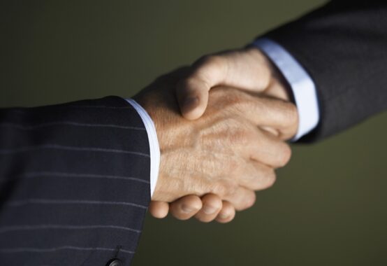 しっかりと握手している男性二人の手のアップ